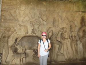 Anne posing with a carving of a Cow licking its calf in Mahabalipuram dating back to the 8th century
