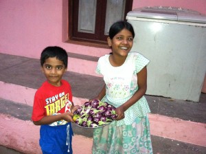 Roshan and Ammu with the eggplants from the earth boxes