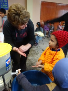 Lauri Molnar teaching handwashing to child in Alto Progreso