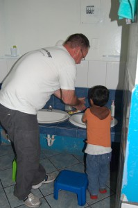 Robert helping with handwashing