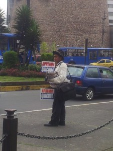 A man on the street in Quito promoting learning Quechua