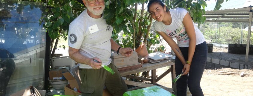 Global Volunteer and student painting table in Costa Rica