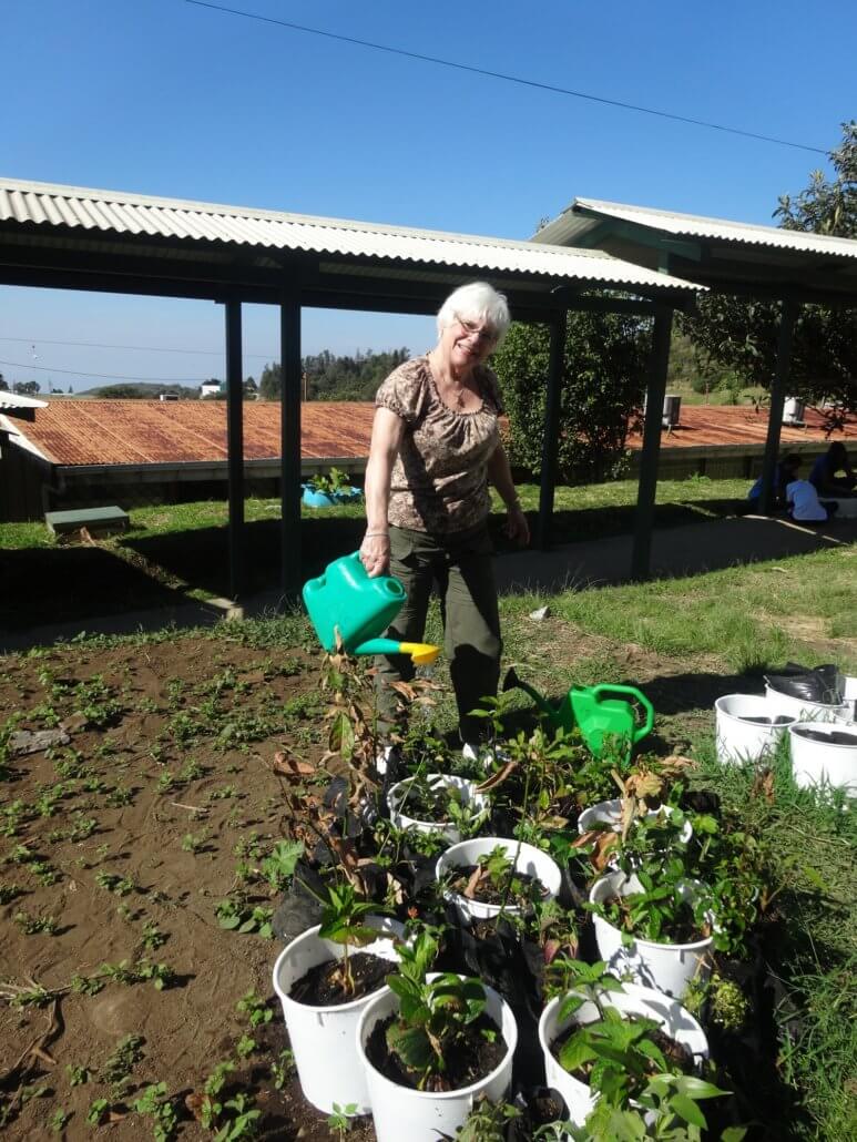 Global Volunteer Barb Chase watering plants in Costa Rica