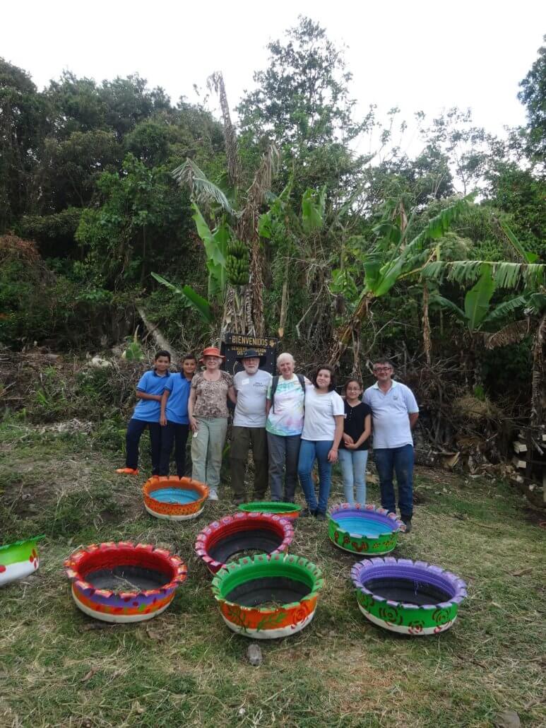 Global Volunteers and students with the beautifully painted tires for planting in Costa Rica