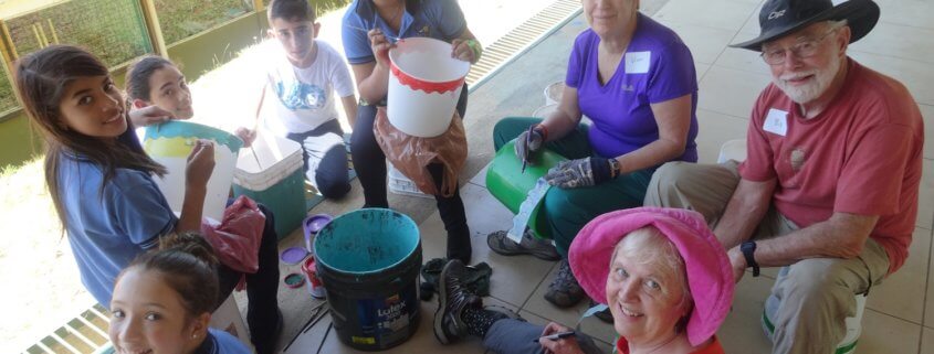 Costa Rica volunteers and students painting ice cream buckets together in Santa Elena, Monteverde