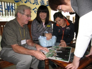 CHI0812A1 Jim Brueggemann shows a family photo to Chinese students