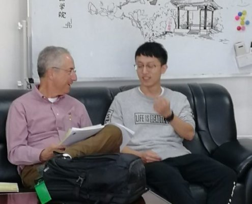 Bob converses with a Chinese student