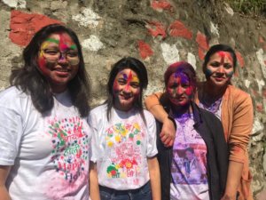 Nepali students covered in color.
