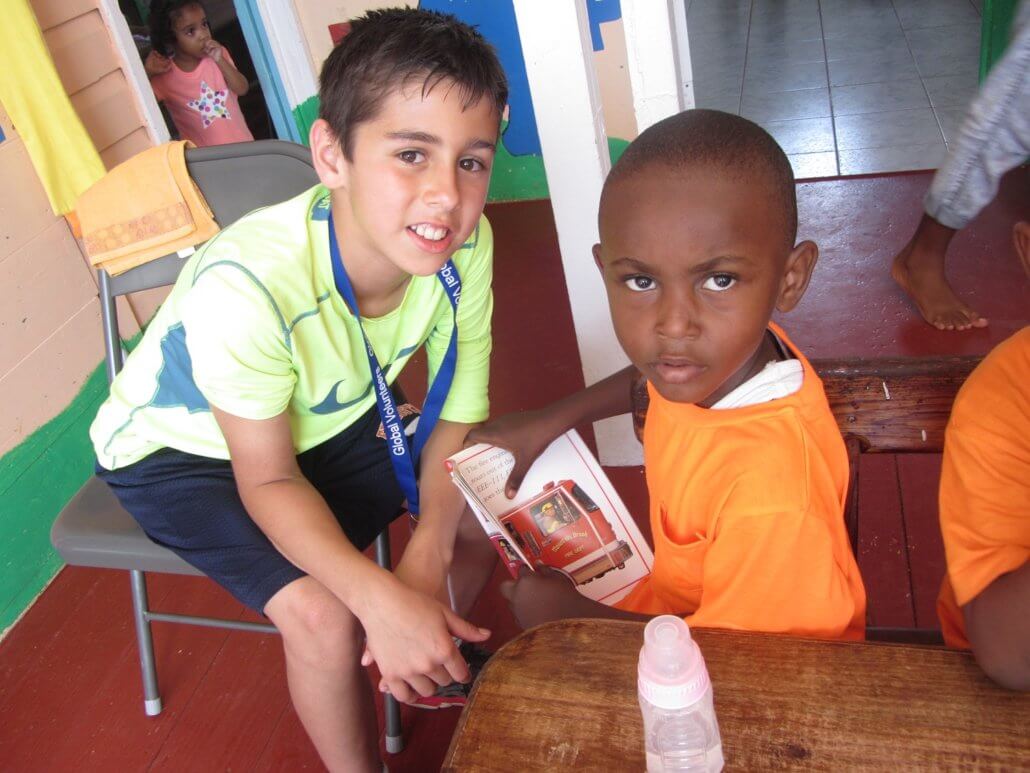 Rowhan poses for a photo while reading to a preschooler in St. Lucia.