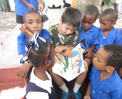 Shaan reads to a group of infant school children in St. Lucia.
