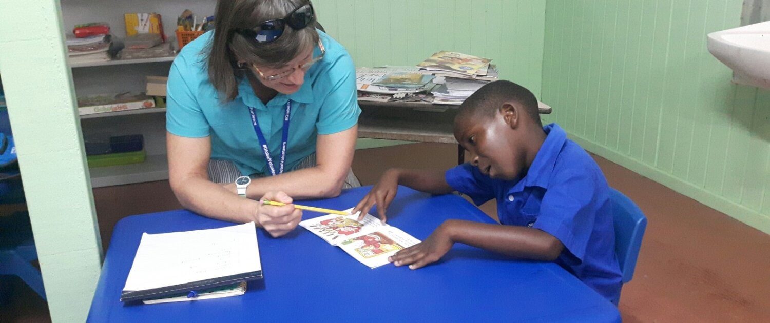 Kathy teaches a student how to sound out blends while reading.