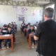 A volunteer in Peru teaches English to 6th graders