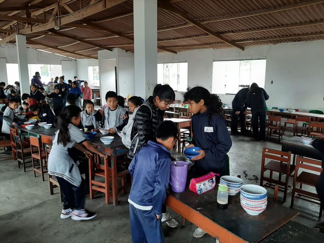 Maya serves lunches to the elementary students in Peru.