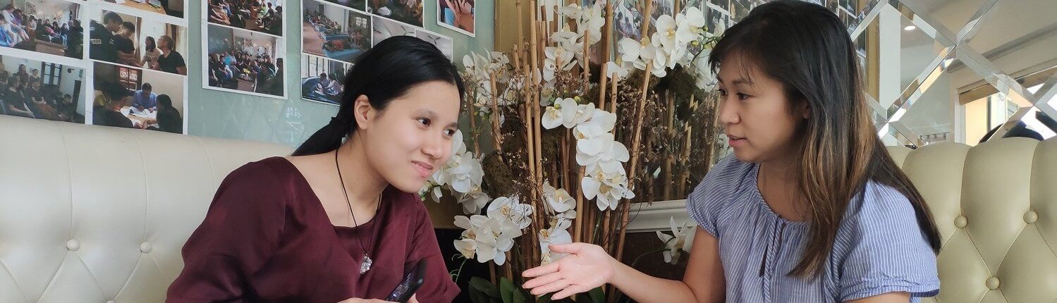 Volunteer converses with visually impaired student in Vietnam