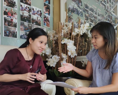 Volunteer converses with visually impaired student in Vietnam
