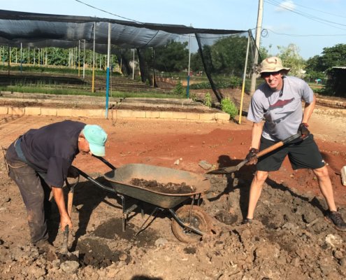 Volunteer abroad helping a local worker on a construction project in Ciego de Avila, Cuba.