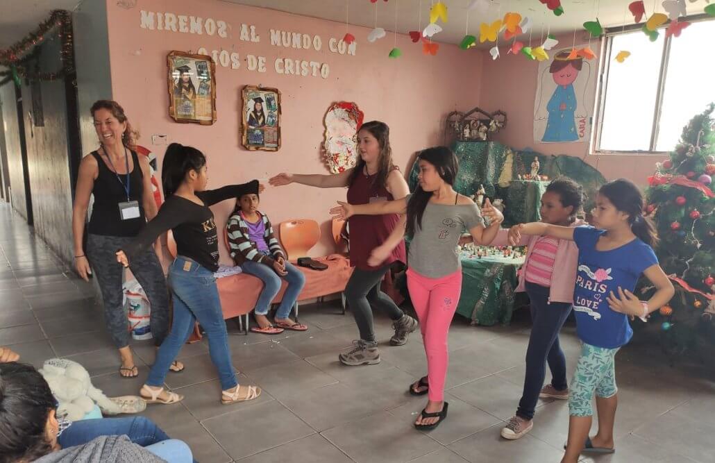 Volunteer dancing children peru