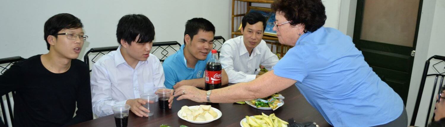 international Volunteer Laura Merriam serves meal to Blind-Link trainees in Hanoi, Vietnam