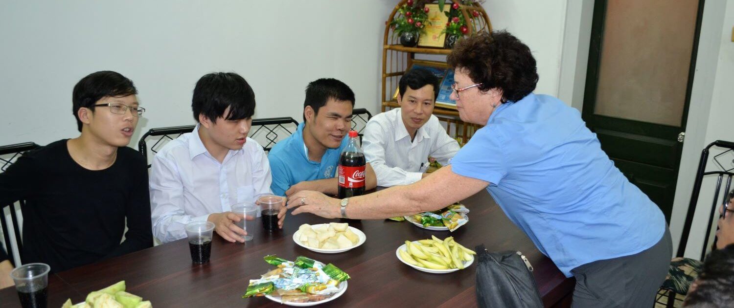 international Volunteer Laura Merriam serves meal to Blind-Link trainees in Hanoi, Vietnam