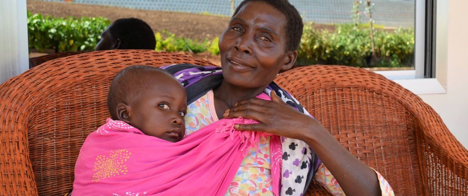 Mom and baby sit outside the RCP center in Ipalamwa, Tanzania. 