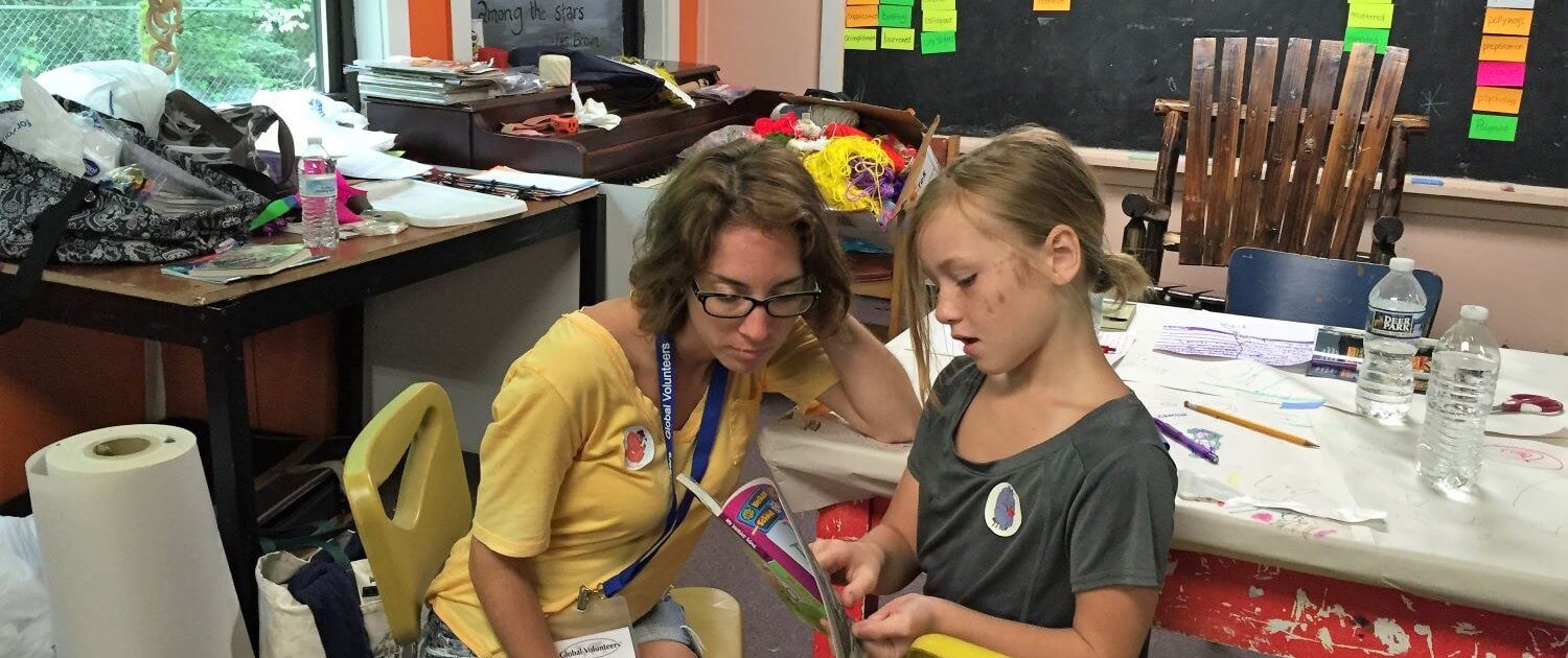 Volunteer works with a local girl at the school.