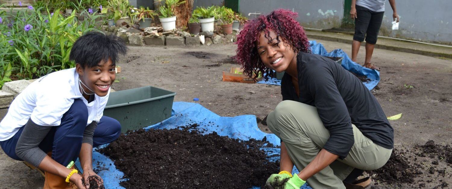 Volunteers-Hannah-Blanks-Syrita-Morgan-help-the-local-people-with-house-gardens-in-St.-Lucia.