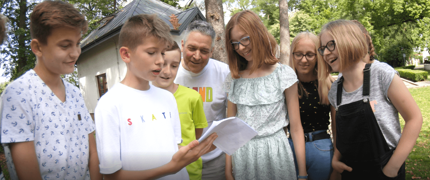 Volunteers Leo Pyzynski teaches Conversational English to Polish children.