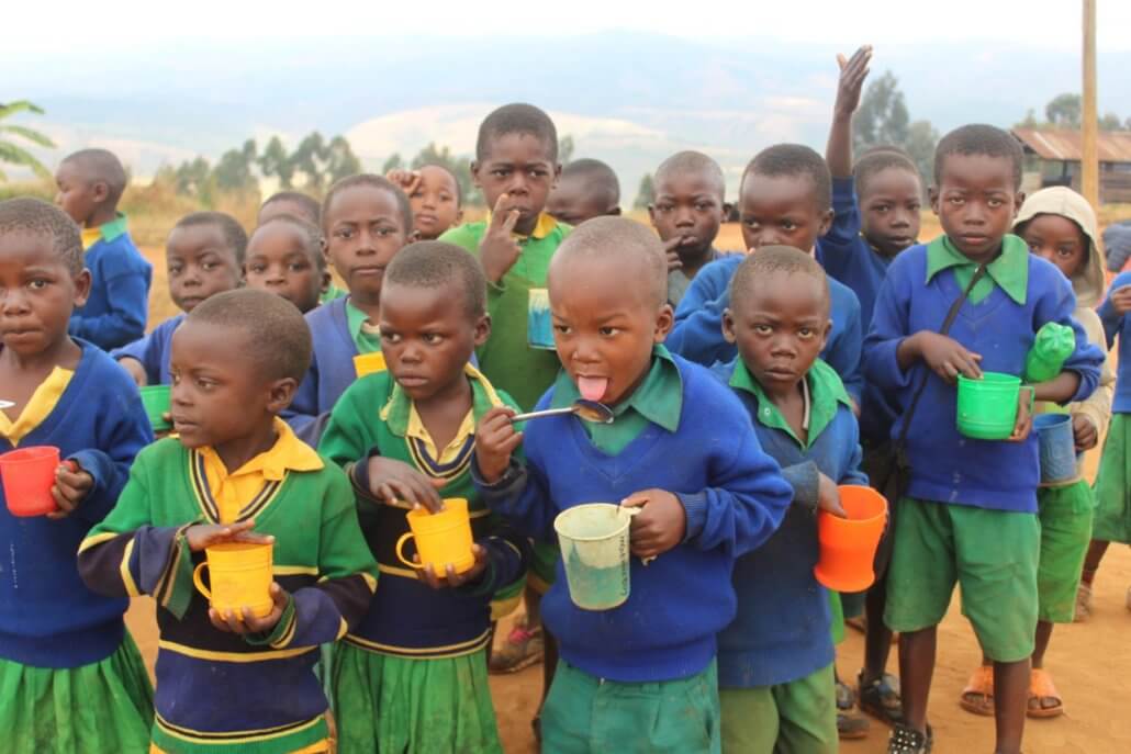 children having porridge at the camp tanzania nutrition
