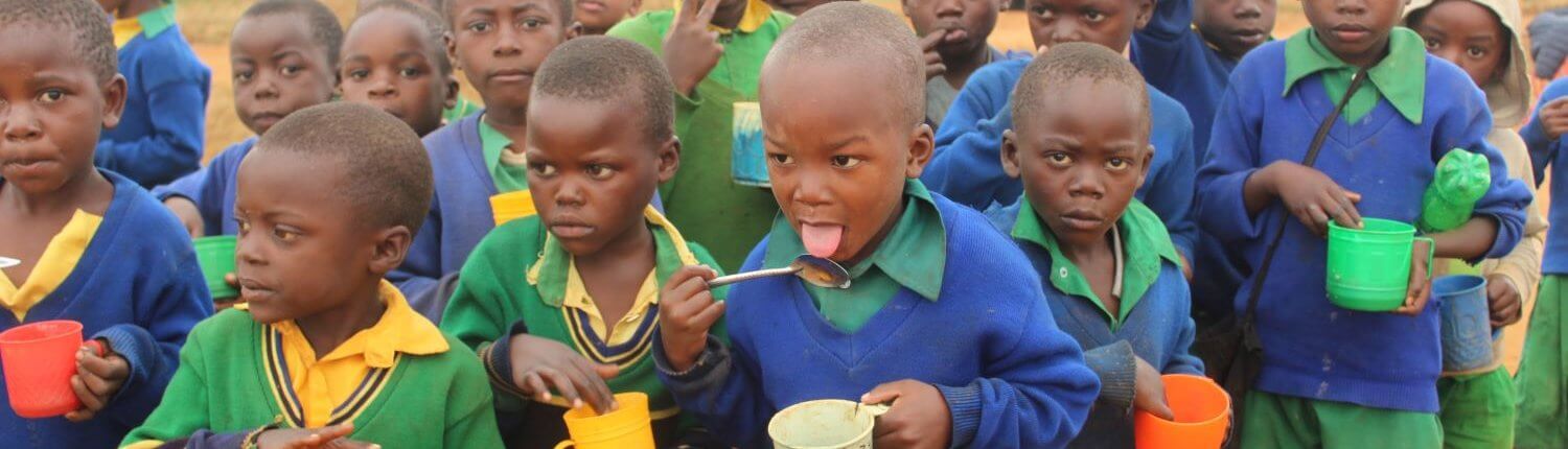 children having porridge at the camp tanzania nutrition