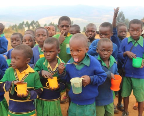 children having porridge at the camp tanzania nutrition