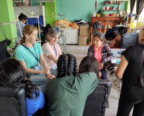 volunteers talk to girls in Peru