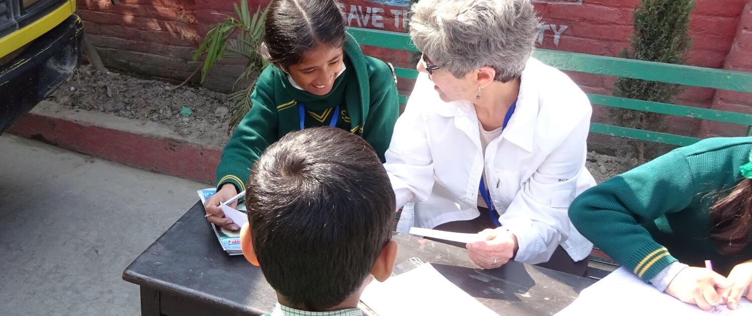Volunteer teaching children at St. Joseph School in Nepal