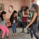 Children in Peru dancing at the Sagrada Familia children's community with volunteers during Christmas season