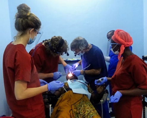 Volunteers Bryan and Maddy Aungst, and Nelson Goodman providing dental care with local staff in Tanzania.