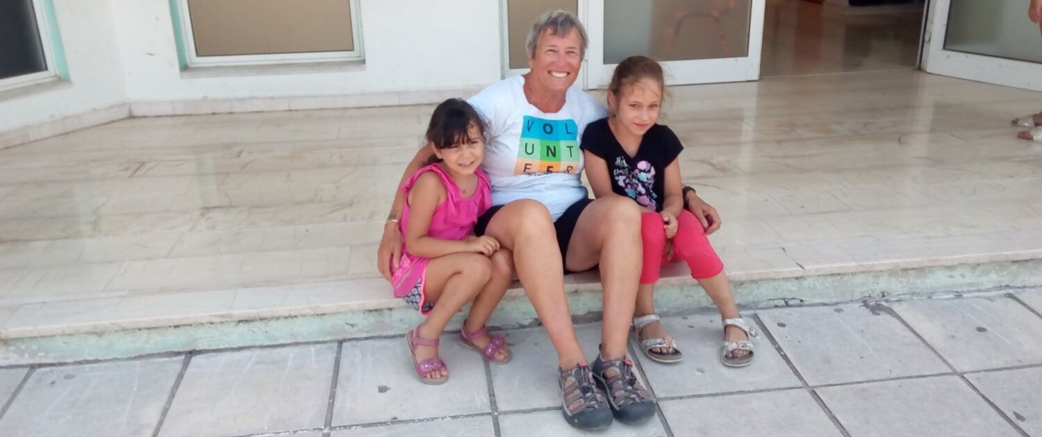 international Volunteer teaches English to girls in Crete, Greece.