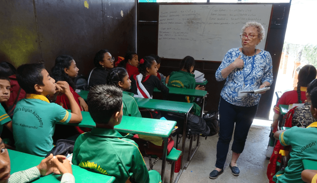 Volunteer teaches English at St. Joseph Academy in Nepal.