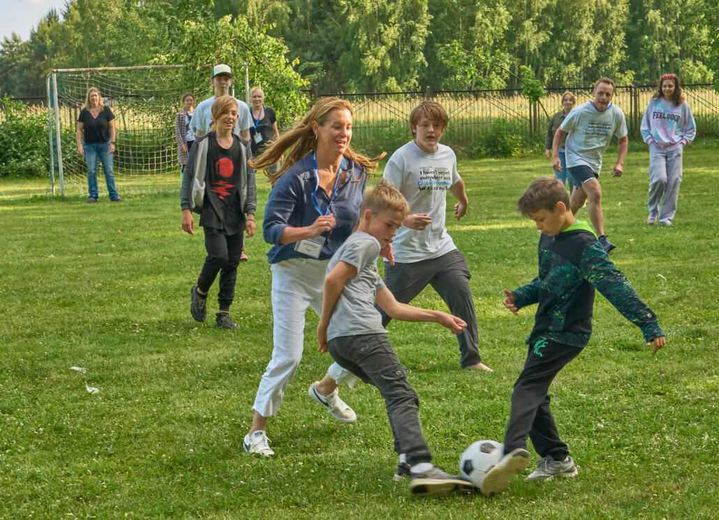 Ukrainian refugee children in Poland play outdoor sports with Global Volunteers team members.