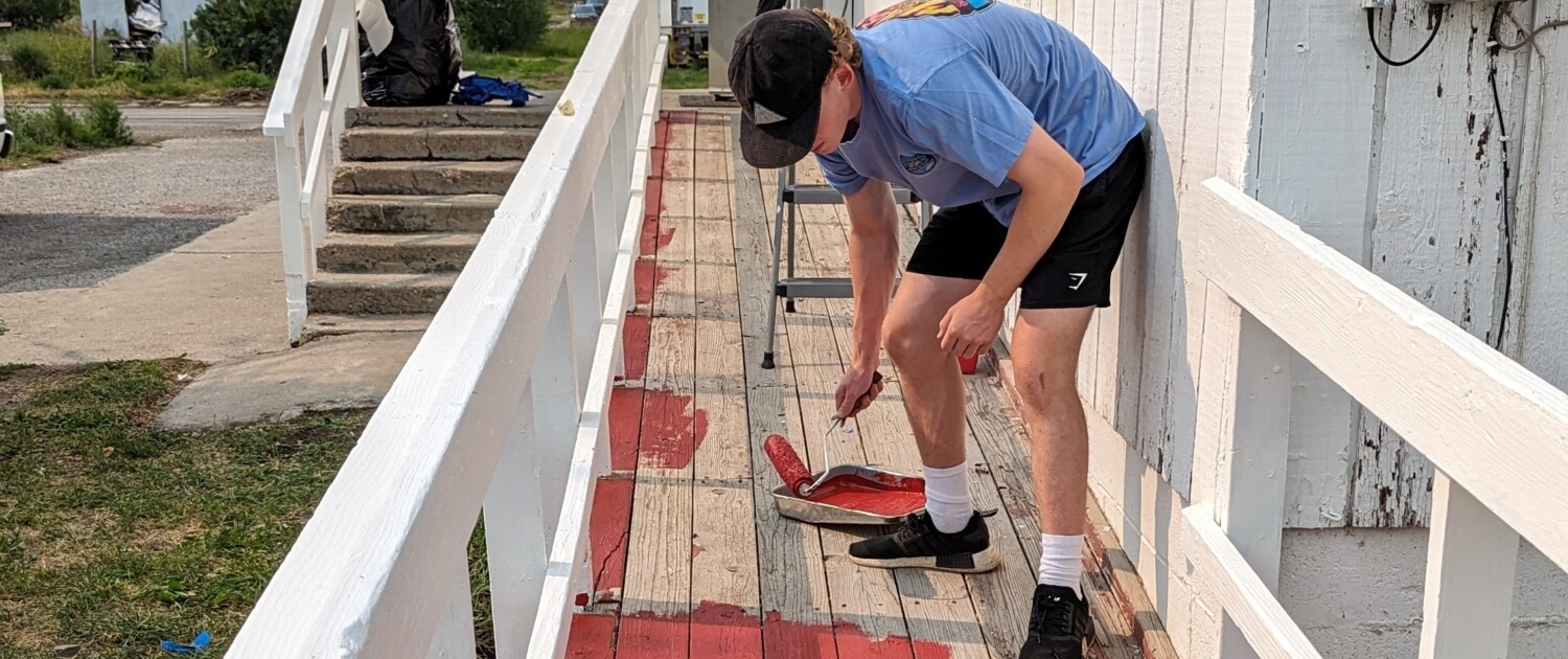 Volunteer Shep Speargas paints handicap ramp at BUMP Church