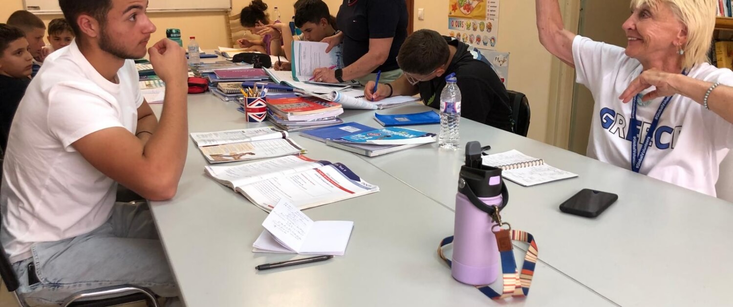 Krebbs teaching with students at Tenia's school