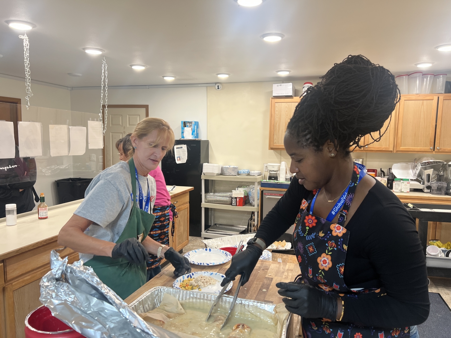 Volunteer Michelle Lebo, Yasmin Togun, cooking Medicine Bear Shelter