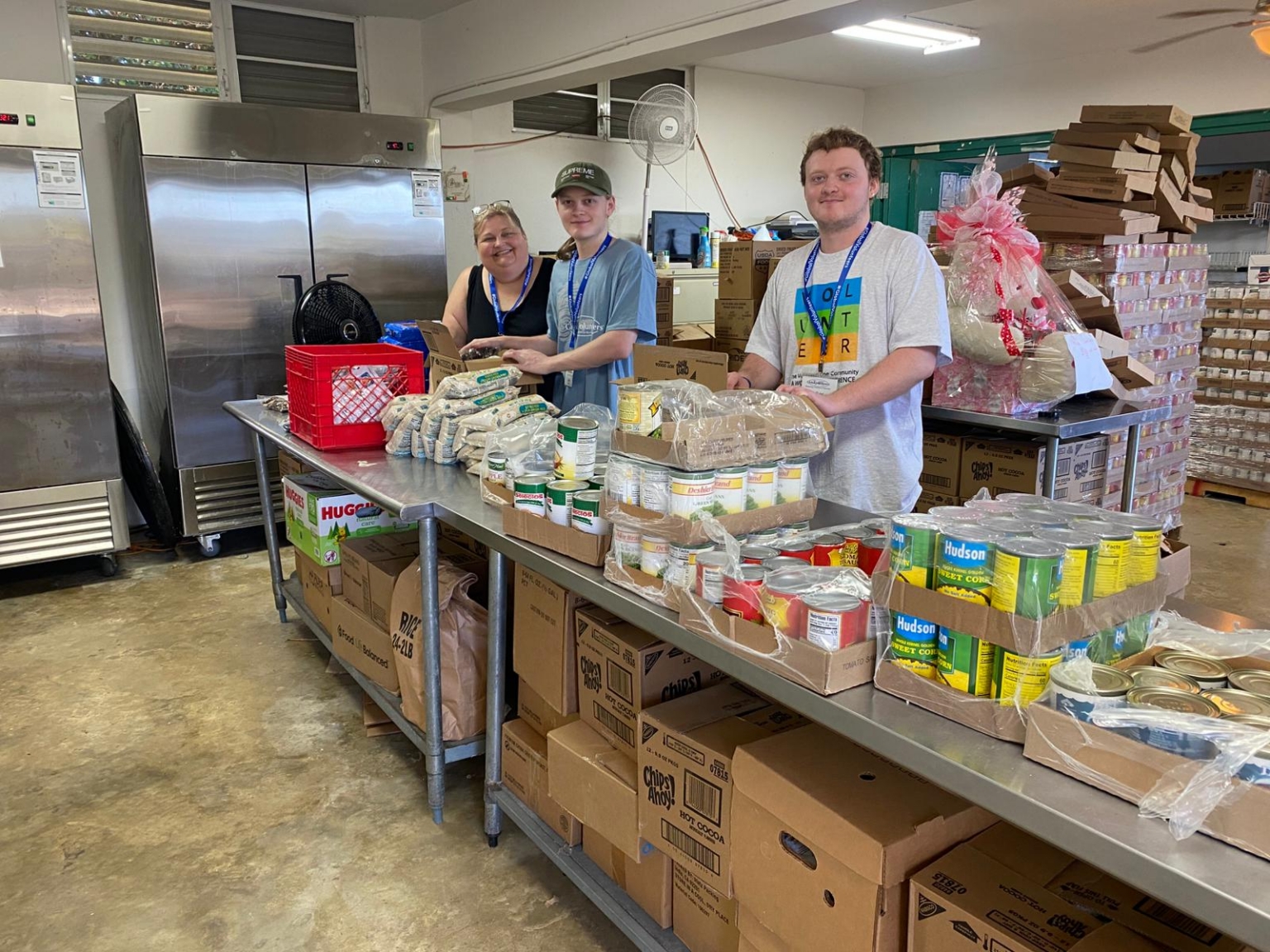 Puerto Rico volunteers Janell Evans Luke Evans Walker Evans pack food boxes at Probienestar