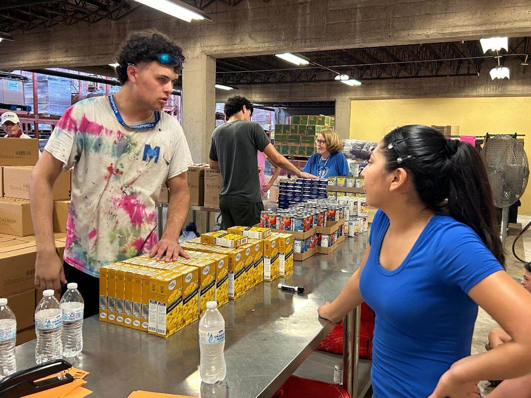 Will Boland talking with America Fuentes at the Food Bank