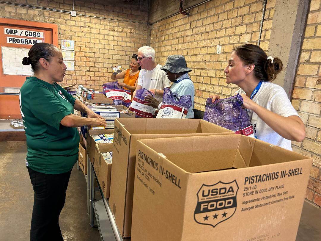Volunteers Working at the Food Bank Elena Munoz, Forrest Perkins, Bill and Monica Hughson