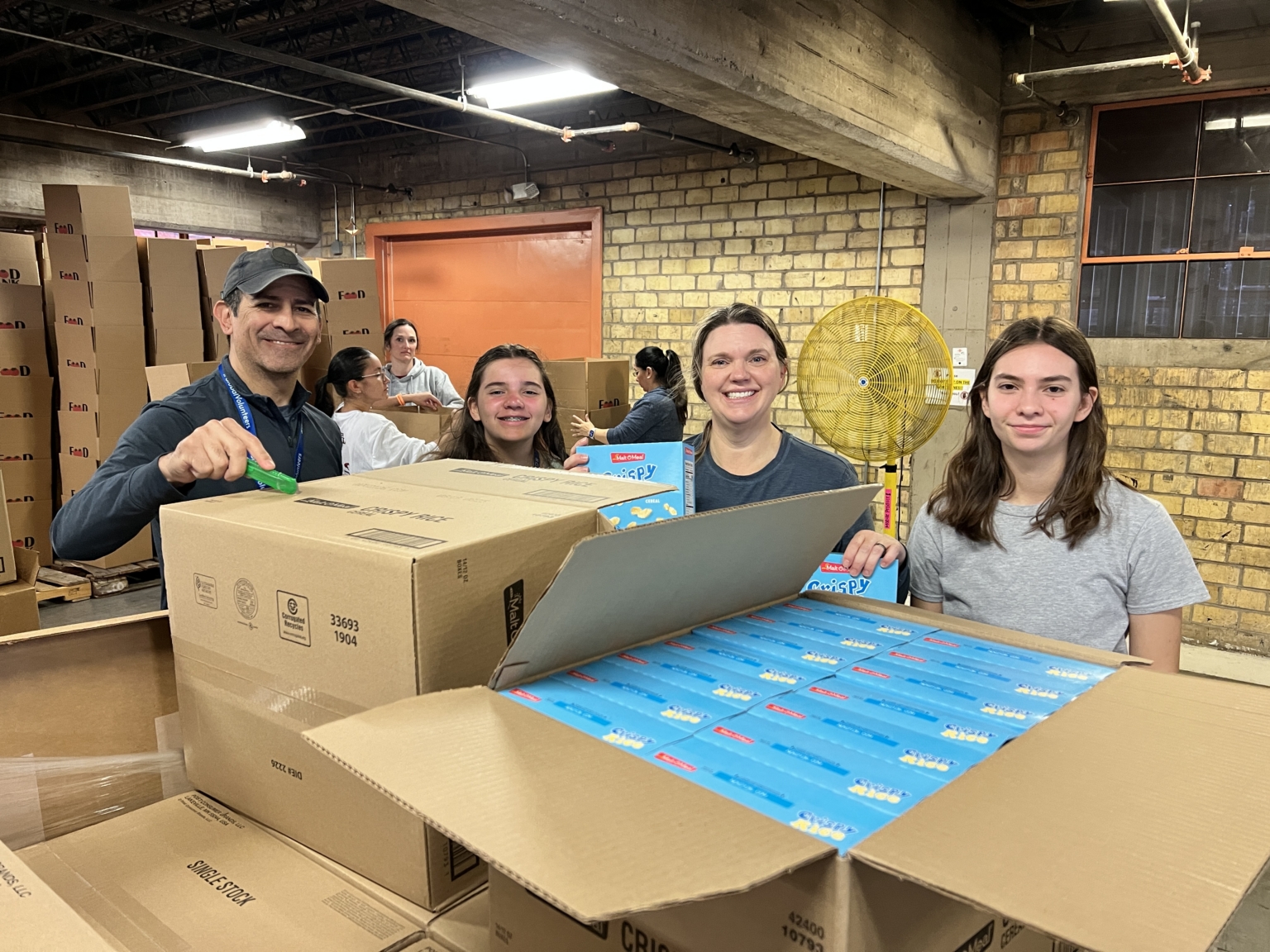Leon Family Volunteers at the Food Bank in Texas